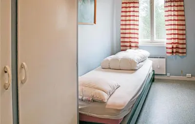 a small room with a bed and a window at Amazing Home In Tufsingdalen With Wifi in Bakken