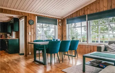 a dining room with a table and blue chairs at Beautiful Home In Engerdal With Kitchen in Kvisla
