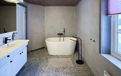 a bathroom with a bath tub and a sink at Lovely Home In Trysil With Wifi in Trysil