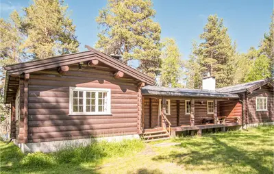 a log cabin with a porch and a deck at Lovely Home In Drevsjø With Lake View in Drevsjø