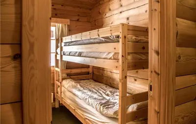 a wooden bunk bed in a log cabin at Lovely Home In Drevsjø With Lake View in Drevsjø