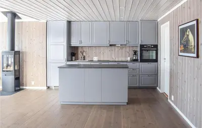 a kitchen with white cabinets and a counter top at 3 Bedroom Amazing Home In Jaren in Jaren