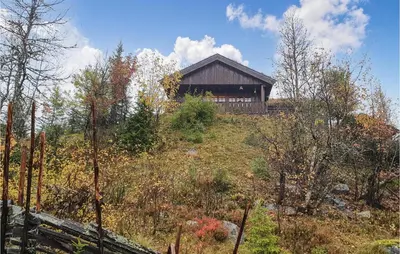 a house on top of a hill with trees at 3 Bedroom Awesome Home In Svingvoll in Svingvoll