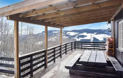 a deck with a bench and a view of the mountains at Awesome Home In Nord-Torpa With Kitchen in Nord Torpa