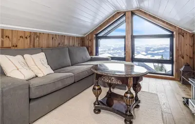 a living room with a couch and a table at 4 Bedroom Lovely Home In Øyer in Øyer