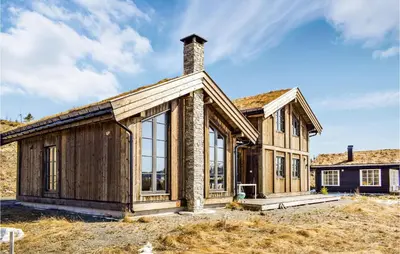 a wooden house with a chimney on top at 4 Bedroom Beautiful Home In Øyer in Øyer