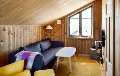 a living room with a couch in a tiny house at 4 Bedroom Beautiful Home In Øyer in Øyer