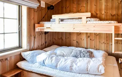 a bedroom with two bunk beds in a cabin at 4 Bedroom Beautiful Home In Øyer in Øyer