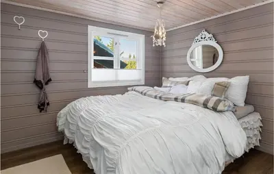 a bedroom with a large white bed with a mirror at Gorgeous Home In Øyer With Sauna in Øyer