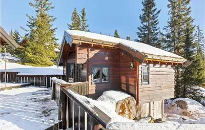 a small wooden cabin in the snow with snow at Gorgeous Home In Øyer With Sauna in Øyer