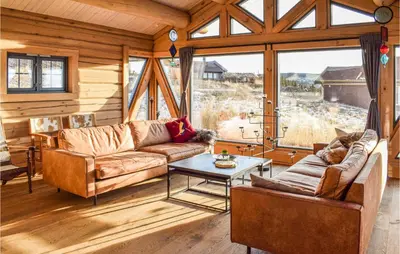 a living room with two couches and a table at Beautiful Home In Øyer With Sauna in Øyer