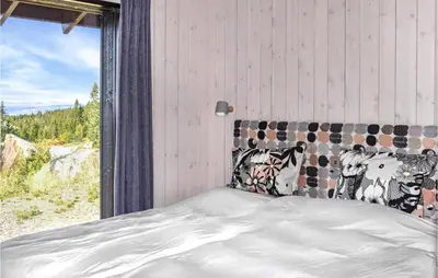 a bedroom with a bed with a view of the mountains at Beautiful Home In Øyer With Sauna in Øyer