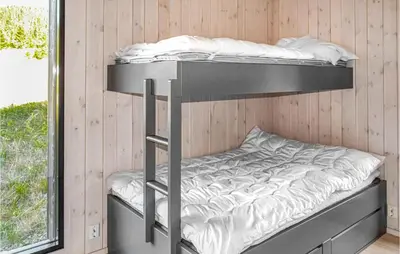 two bunk beds in a room with a window at Beautiful Home In Øyer With Sauna in Øyer
