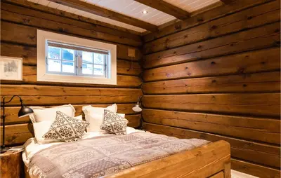 a bedroom with a bed in a log cabin at Solbergsætra in Øyer