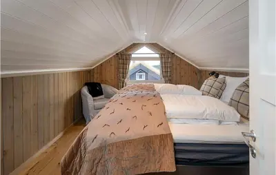 a bedroom with a bed in a room with a window at Gorgeous Home In Sjusjøen With Kitchen in Sjusjøen