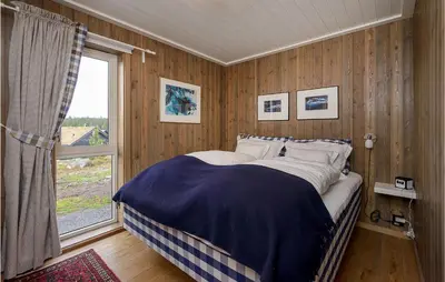 a bedroom with a large bed with a window at Gorgeous Home In Sjusjøen With Kitchen in Sjusjøen