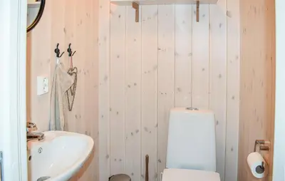 a bathroom with a white toilet and a sink at 4 Bedroom Stunning Home In Øyer in Øyer