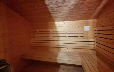 a wooden sauna with a bench in a room at Amazing Home In Sjusjøen With Sauna in Sjusjøen