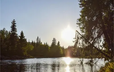 a view of a river with the sun setting at Amazing Home In Sjusjøen With Sauna in Sjusjøen