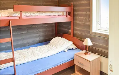 a bunk bed room with two bunk beds and a lamp at 3 Bedroom Amazing Home In Sjusjøen in Sjusjøen