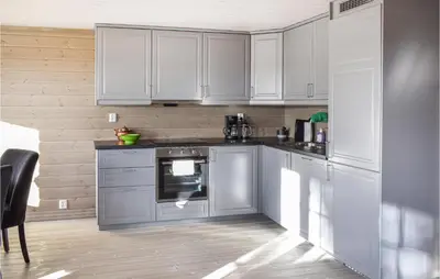 a kitchen with white cabinets and an oven at 3 Bedroom Amazing Home In Sjusjøen in Sjusjøen