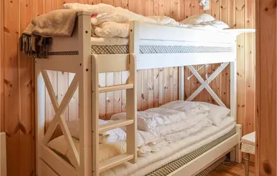 a couple of bunk beds in a room at Nice Home In Sjusjøen With Kitchen in Sjusjøen