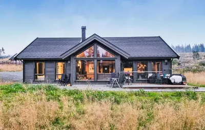 a house with a black roof and windows at Lovely Home In Lillehammer With Kitchen in Lillehammer