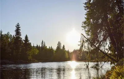 a river with the sun reflecting on the water at Lovely Home In Lillehammer With Kitchen in Lillehammer
