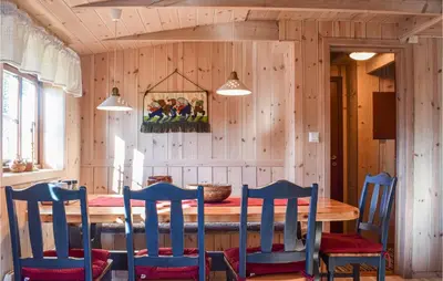 a dining room with a wooden table and chairs at Sjusjøen Pihl 4001 in Sjusjøen