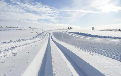 a road covered in snow in a field at Nice Home In Sjusjøen With Wifi in Sjusjøen