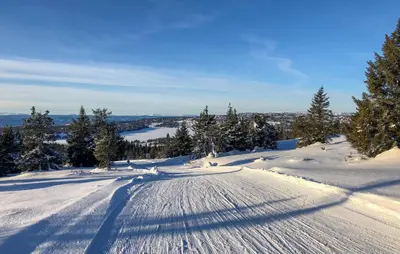 a road covered in snow with trees on a mountain at Nice Home In Sjusjøen With Wifi in Sjusjøen