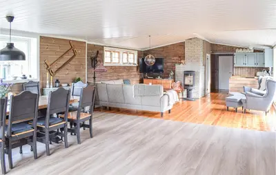 a living room with a couch and a table at Cozy Home In Sjusjøen in Sjusjøen