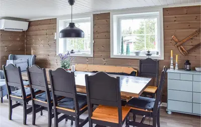 a dining room with a table and chairs at Cozy Home In Sjusjøen in Sjusjøen