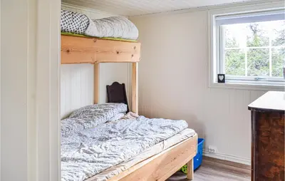 a bedroom with a bunk bed and a window at Cozy Home In Sjusjøen in Sjusjøen