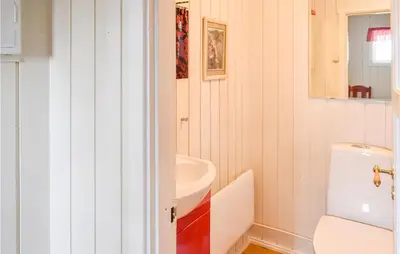 a bathroom with a white toilet and a sink at 4 Bedroom Nice Home In Sjusjøen in Sjusjøen