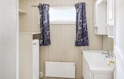 a small bathroom with a sink and a window at 4 Bedroom Nice Home In Sjusjøen in Sjusjøen