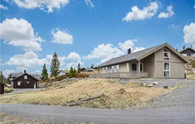 a house sitting on top of a grassy hill at 4 Bedroom Beautiful Home In Sjusjøen in Sjusjøen