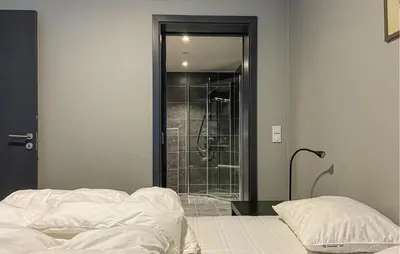 a bedroom with a shower and a bed and a glass door at Leil 70 in Sjusjøen