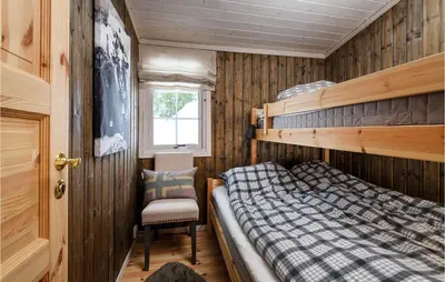 a bedroom with a bunk bed and a chair at 4 Bedroom Gorgeous Home In Sjusjøen in Sjusjøen
