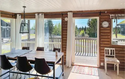 a dining room with a wooden table and chairs at 4 Bedroom Amazing Home In Lillehammer in Lillehammer