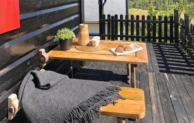 a wooden table and bench on a wooden deck at Nice Home In Reinli With Kitchen in Reinli