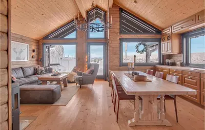 a kitchen and living room with a table and a couch at Nice Home In Reinli With Kitchen in Reinli