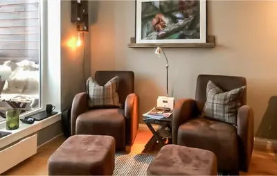 a living room with two chairs and a table at 2 Bedroom Cozy Apartment In Geilo in Geilo