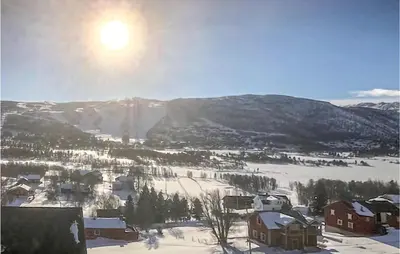 a village in the snow with the sun in the sky at 2 Bedroom Cozy Apartment In Geilo in Geilo