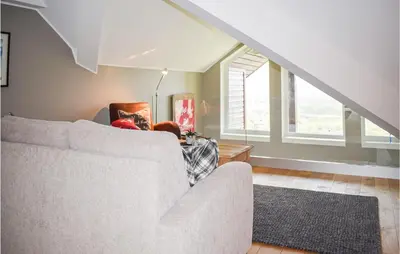 a living room with a couch and a table at 2 Bedroom Cozy Apartment In Geilo in Geilo