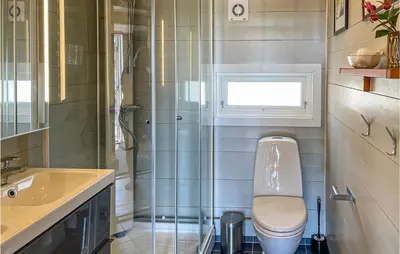 a bathroom with a toilet and a sink and a shower at 3 Bedroom Awesome Home In Eggedal in Eggedal