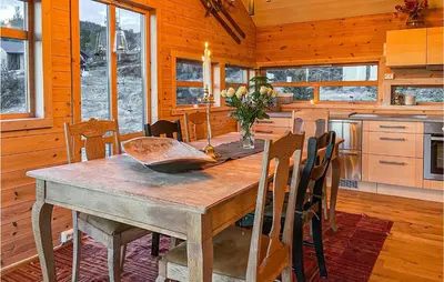 a dining room with a wooden table and chairs at 3 Bedroom Awesome Home In Eggedal in Eggedal