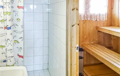 a bathroom with a shower and a white tiled wall at Stunning Home In Uvdal With Wifi in Uvdal