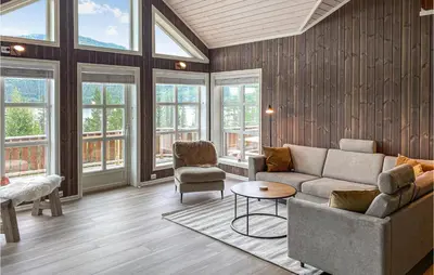 a living room with a couch and chairs and windows at Beautiful Home In Rødberg in Rødberg
