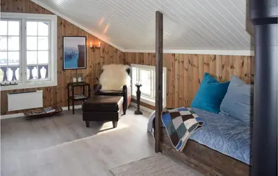 a bedroom with a bed and a chair at 4 Bedroom Awesome Home In Eggedal in Eggedal